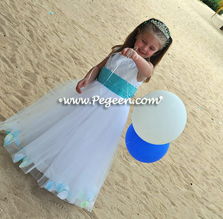 Custom flower girl girl dress in white tulle and trellis silk with bahama breeze sash and shells in the skirt