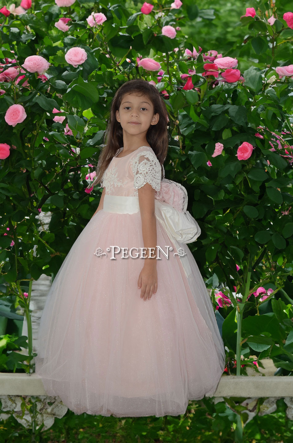 Flower girl dress Style 413 in peony pink with aloncon lace and Pegeen Signature Bustle